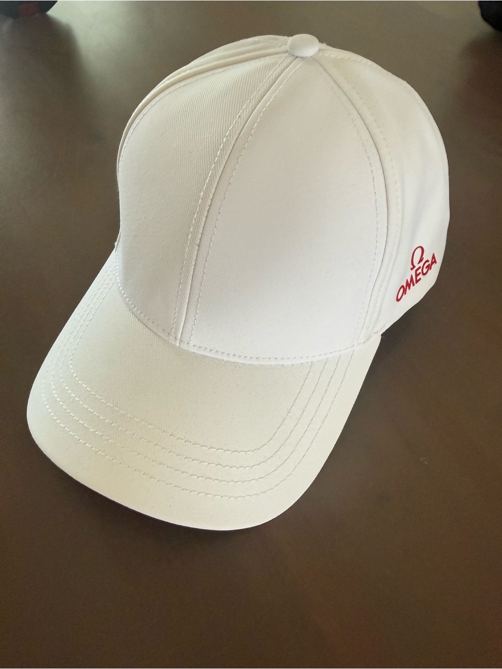 Omega Mens White Cap with Red Logo